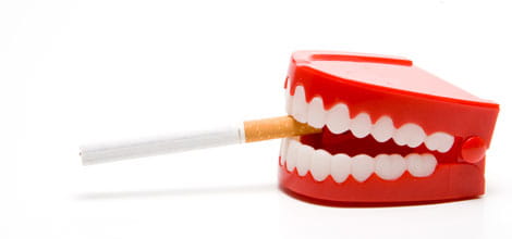False teeth holding cigarette